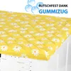A yellow cover with white daisy patterns is placed on top of a white washing machine. Anteprima dell’immagine prodotto