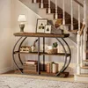 A console table with decorative items placed on it, situated next to a staircase. Podgląd zdjęcia produktu