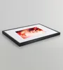 A framed picture with a woman's face and autumn leaves. Produktbild-Vorschau