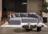 A modern living room with a large sectional sofa, coffee tables, and a fireplace. Produktbild-Vorschau