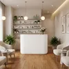 A reception desk in a spa or salon with seating and shelves of products. Produktbild-Vorschau