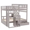 A gray wooden bunk bed with stairs and storage drawers, shown from a three-quarter angle against a white background. Náhled obrázku produktu