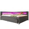 A grey upholstered daybed with LED lighting in the headboard, a green throw blanket, and orange and blue pillows on a white background. Voir les images du produit