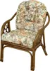 A rattan armchair with floral cushions. Produktbild-Vorschau