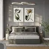 A bedroom scene with a bed, nightstands, and artwork. Anteprima dell’immagine prodotto