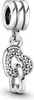 A silver charm with two intertwined hearts, one encrusted with clear stones, hangs from a ribbed bail. Podgląd zdjęcia produktu