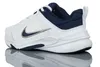 A white and navy blue Nike shoe is shown from the side against a white background. Voir les images du produit