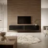 A modern living room with a wall-mounted TV stand and a large TV. Voir les images du produit