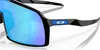 Close-up shot of a pair of black Oakley sunglasses with blue mirrored lenses. Náhled obrázku produktu