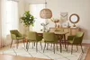 A dining room scene with a table and chairs, decorated with plants and wall art. Produktbild-Vorschau