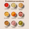 A grid of nine small bowls, each containing a different food ingredient, with German labels below each bowl. Produktbild-Vorschau