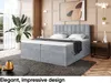 A bedroom scene featuring a large upholstered bed with storage, a nightstand, a plant, and decorative elements. Produktbild-Vorschau