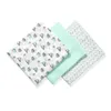 Three baby muslin cloths are arranged diagonally on a white background. The cloths have different patterns: one with cartoon sloths, one solid mint green, and one with small gray dots. Produktbild-Vorschau