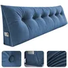 A blue wedge pillow with tufted buttons and a side pocket. Produktbild-Vorschau