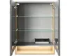An open medicine cabinet with glass shelves and an integrated power outlet. Anteprima dell’immagine prodotto