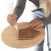 A person is decorating a gingerbread house piece with white icing. Voir les images du produit