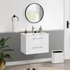 A modern bathroom vanity with a sink and faucet, a round mirror, a towel rack, and a trash can. Produktbild-Vorschau