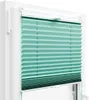 A close-up view of a turquoise pleated blind installed in a white window frame. Anteprima dell’immagine prodotto