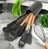 A set of kitchen utensils in a holder, with some greenery in the background. Náhľad obrázku produktu