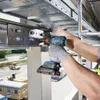 A person wearing work gloves is using a Bosch cordless drill to attach a metal bracket to a suspended metal channel. Produktbild-Vorschau