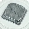 A close-up view of a metal grate with many small holes, likely a component of a larger appliance. Podgląd zdjęcia produktu