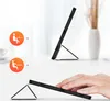 A black tablet case is shown in two different orientations, demonstrating its stand functionality. Two circular icons with figures using laptops are shown on the left, indicating different usage modes. Náhľad obrázku produktu