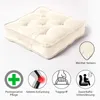 A cream-colored square cushion is shown on a white background, with several icons and text describing its features. Náhled obrázku produktu
