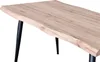 A close-up of a table with a live edge wood top and black metal legs. Produktbild-Vorschau