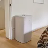 A laundry basket is placed next to a doorway in a room with wooden floors. Produktbild-Vorschau