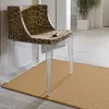 A chair with a leopard print upholstery and clear acrylic legs sits on a beige rug in a hallway. Produktbild-Vorschau