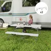 A woman sits at a picnic table next to a camper van. Produktbild-Vorschau