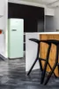 A modern kitchen with a retro-style refrigerator and bar stools. Produktbild-Vorschau