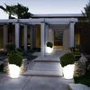 A modern house entrance at dusk, illuminated by glowing planters. Produktbild-Vorschau
