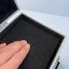 A hand is pressing into the foam lining of an open aluminum case. Produktbild-Vorschau