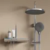 A modern chrome shower system with a large rain shower head, a handheld shower head, and a control panel with a digital display and ambient lighting. Anteprima dell’immagine prodotto