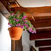 A hanging flower pot with pink and purple flowers on a wooden beam. Produktbild-Vorschau