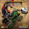 A child in riding gear is sitting on a green and black electric quad bike in a sandy, outdoor environment. Produktbild-Vorschau