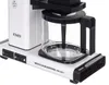 A close-up view of a white Moccacoffee maker with a glass carafe. Produktbild-Vorschau