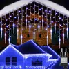 Icicle lights are decorating a house roof and eaves during winter. Produktbild-Vorschau