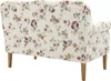 The back view of a floral patterned sofa with wooden legs. Produktbild-Vorschau