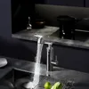 A modern kitchen sink area with a faucet dispensing water. Produktbild-Vorschau