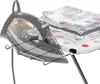 A close-up shot of an iron resting on a metal stand, next to a stack of folded towels on an ironing board. Produktbild-Vorschau