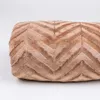 A close-up view of a brown blanket with a chevron pattern. Podgląd zdjęcia produktu
