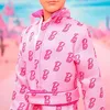 Close-up of a doll wearing a pink patterned robe. Produktbild-Vorschau
