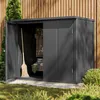 A dark gray metal garden shed with its doors open, revealing gardening tools and supplies inside. The shed is situated outdoors against a wooden fence, with grass and bushes in the foreground. Náhled obrázku produktu