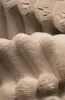 Close-up view of textured beige fabric, likely part of a piece of furniture like a bed or sofa. Náhled obrázku produktu