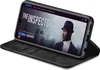 A smartphone in a black flip case is displayed at an angle, showing a movie streaming interface on its screen. Produktbild-Vorschau