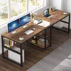 A spacious wooden desk with black metal legs, set up in a room with a large window and a patterned rug. Náhled obrázku produktu