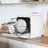 A white countertop dishwasher is shown with its door open, displaying dishes inside. Dimensions are indicated with measurement lines and text. Produktbild-Vorschau