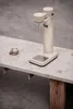 A beige Aarke Carbonator 3 sits on a concrete countertop next to a glass. Produktbild-Vorschau